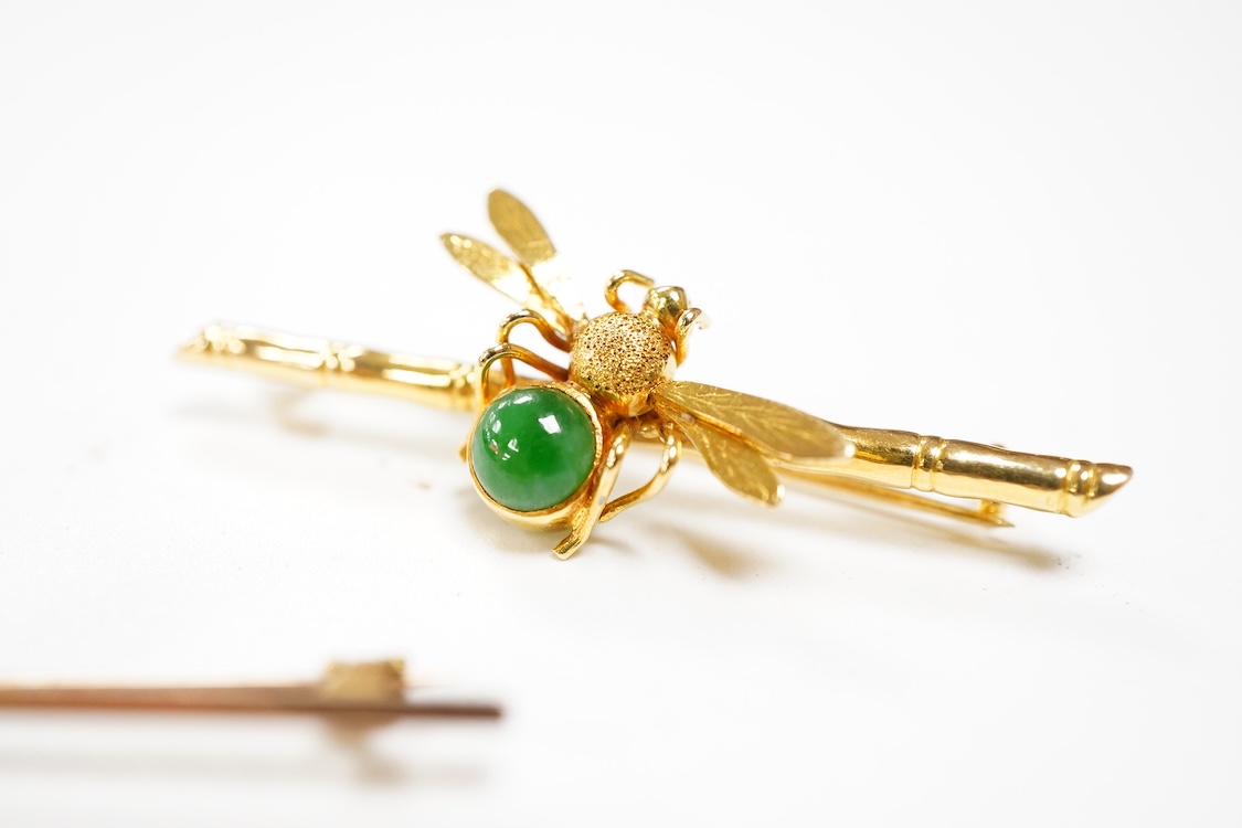 An Edwardian two colour 9ct owl bar brooch, with green cabochon eyes, 48mm, gross 2.5 grams, together with a yellow metal (stamped 20) and single stone cabochon jade set bug bar brooch, gross weight 3.7 grams.